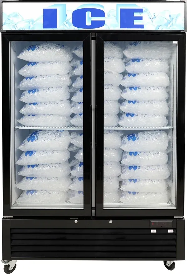 Two-door ice display freezer fully stocked with bagged ice beneath a backlit ICE sign